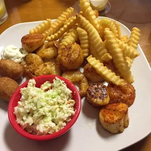 Grilled scallops and shrimp with fries, coleslaw and hush puppies.