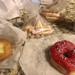 a doughnut, a bagel, and a cup of coffee