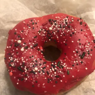 a red donut with sprinkles