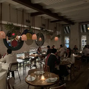 people sitting at tables in a restaurant