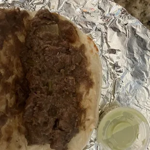 Inside the Carne Guisada taco, mini salsa shot in for size. Good flavor and texture. 09OCT24