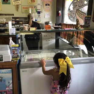 a little girl reaching for ice cream