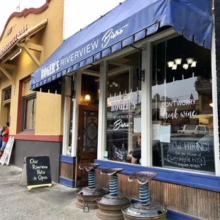 Street view. Three bar stools in front as waiting area