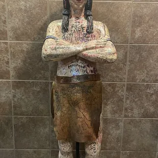 a statue of a woman with her arms crossed