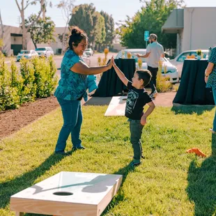 You'd be high-fiving too if you were here playing cornhole.