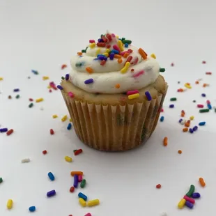 Sprinkle cupcakes filled and topped with sprinkle loaded buttercream