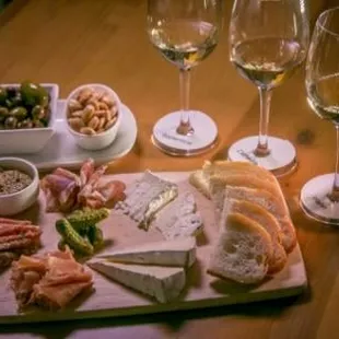 a cheese board with a variety of appetizers