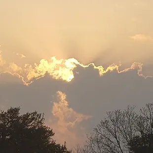 the sun shining through the clouds