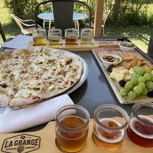 Mead samples on top, pizza, cheese and meat platter and ciders and beers samples on bottom.