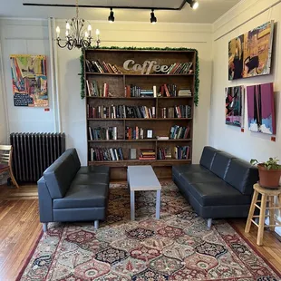 a living room with a rug and couches