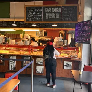 a woman standing in front of the counter