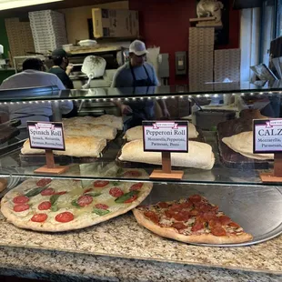 Different pizza  rolls and some slices