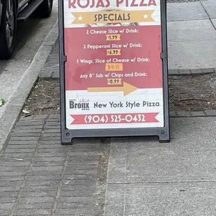 a sign for rojas pizza specials