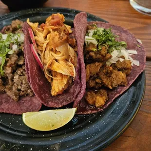 Carne asada, chicken tinga, and al pastor tacos