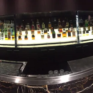 a bar with a lot of liquor bottles