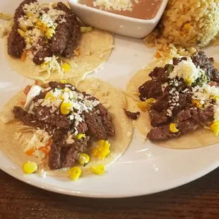 Carne asada tacos on corn tortillas