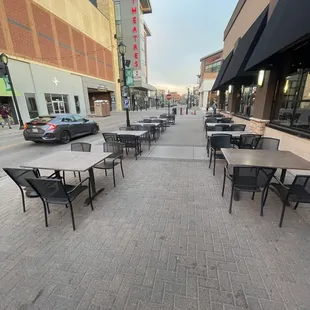 tables and chairs on a sidewalk