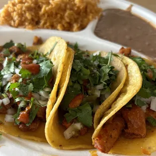 Carne asada taco, al pastor taco, rice and beans.