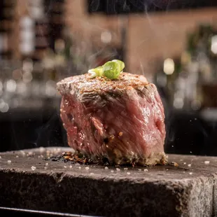 filet cooking on rock