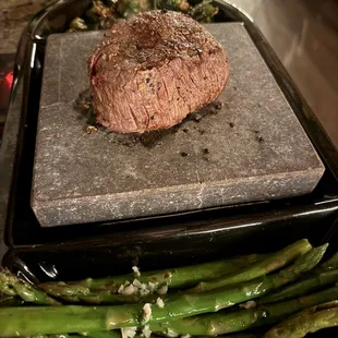Filet mignon on hot rock. The best way to eat it. I also tossed the asparagus on the hot rock and sear those as well.