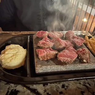Prime rib cap cooked on a hot stone.