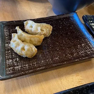 three dumplings on a plate