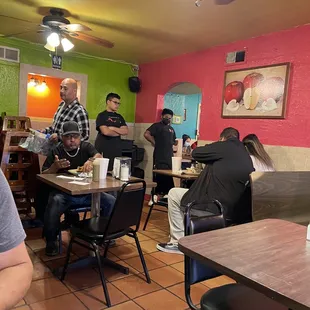 The bus boys in the back waiting too clear tables .