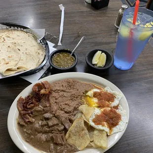 2 eggs red sauce, bacon, carne guisada, bacon, beans, potatoes, 2 huge homemade tortillas with giant glass of water w/fresh lemons.
