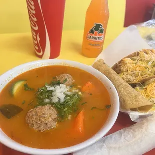 The Albondigas caldo &quot;meatball soup&quot; with veggies in a delicious broth and crunchy tacos with rice cinnamon drink.