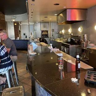 The raw bar chefs schucks the clams and oysters here.