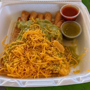 Rolled tacitos with guacamole. Red salsa is caliente!