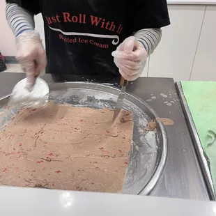 a man in a black shirt making a cake
