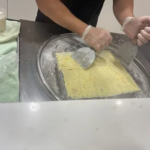 a woman in a black shirt making a pie