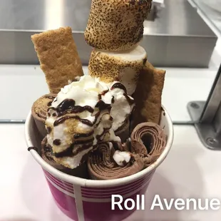 a cup of ice cream with chocolate and marshmallows