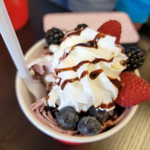 a bowl of ice cream and berries