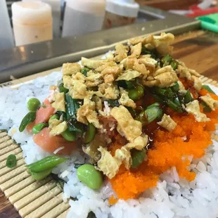 Sushi burrito with fresh salmon, fish eggs, and a slew of other delicious fillers and toppers!