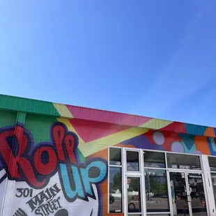 he outside of a restaurant with a colorful mural