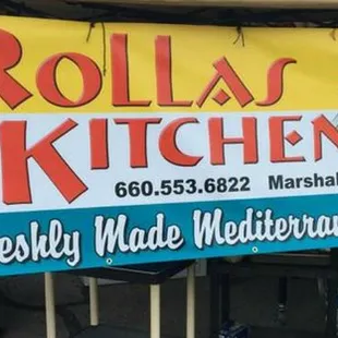 a woman standing in front of a food truck