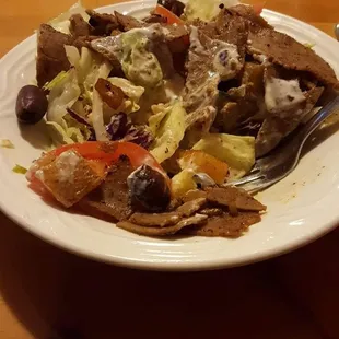 Lunch Greek salad with gyro meat comes with warm pita bread.