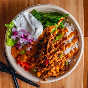 Tender Beef Barbacoa Rice Bowl with Spinach, Onions, Tomatoes, Sauteed Green Peppers, Chipotle and Tzatziki.