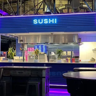 a sushi restaurant with neon lights