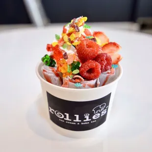 a cup of ice cream with fruit on top
