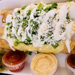3 Chicken Rolled Tacos with assorted dipping sauces. Red, green, cheese. So delicious!