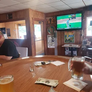 a man sitting at a table with a glass of beer