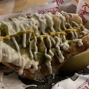 The full pic of the Sonoran dog. A lot of sauces on top.