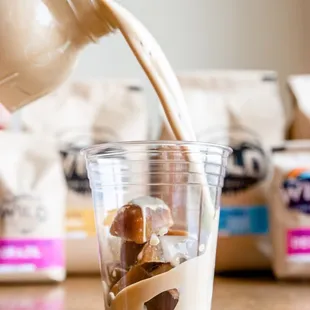milk being poured into a cup
