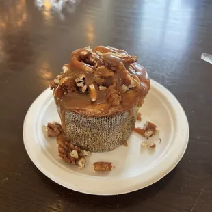 Cream cheese cinnamon roll with added caramel drizzle and pecans