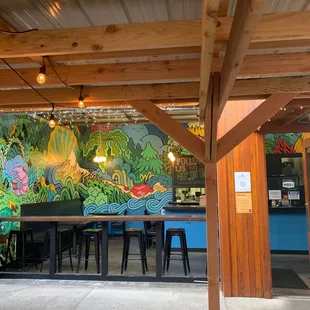  restaurant with a mural on the wall