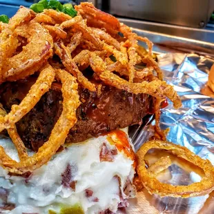 Smoked meatloaf! Loaded mash potatoes topped with meatloaf, Mama&apos;s sweet D-licious sauce and fried onion strings!!