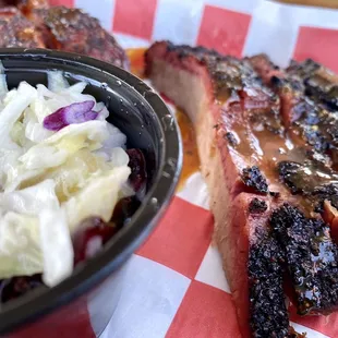  bowl of coleslaw and ribs